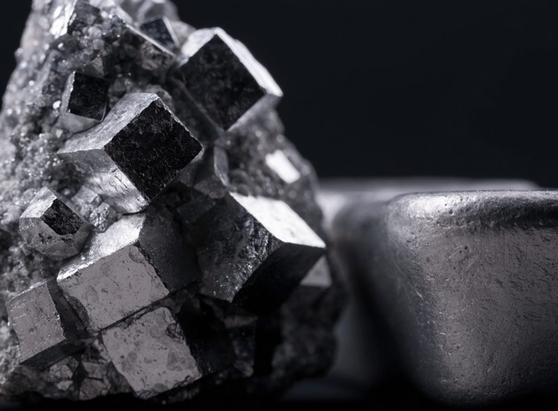 Galena crystals beside a lead ingot